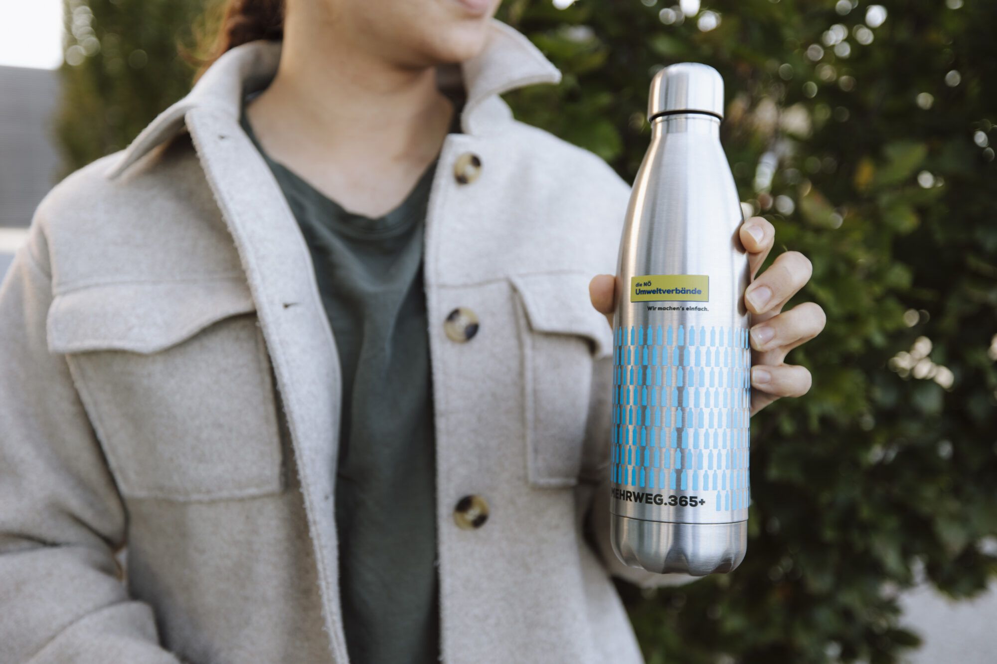 Eine Mehrweg Stahlflasche wird zum Mund gef&uuml;hrt.